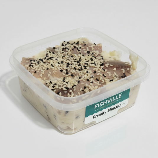 Container of creamy shmaltz herring with sesame seeds featuring the Fishville brand.